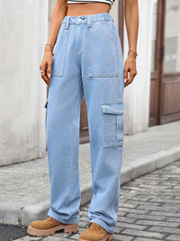 Person wearing light blue cargo jeans on a street.