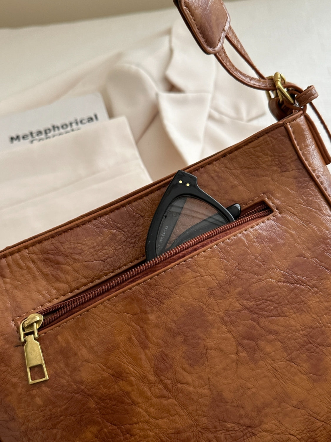 A view of the side pocket on brown PU Leather Adjustable Strap Crossbody Bag with Pouch