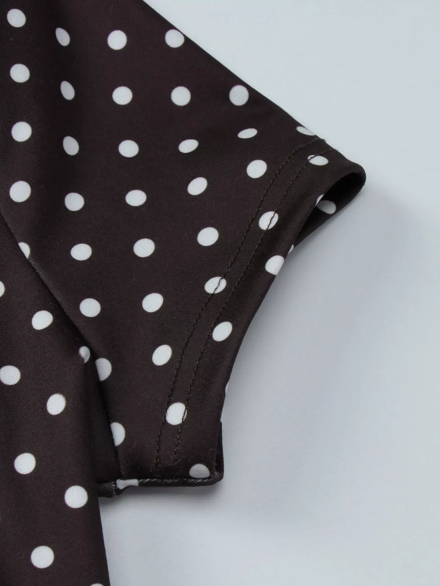 Close-up of a brown fabric with white polka dots on a light gray background