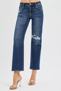 Blue jeans with slight distressing on a white background