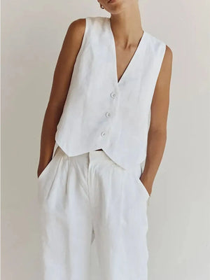 Person wearing a white vest over a plain background