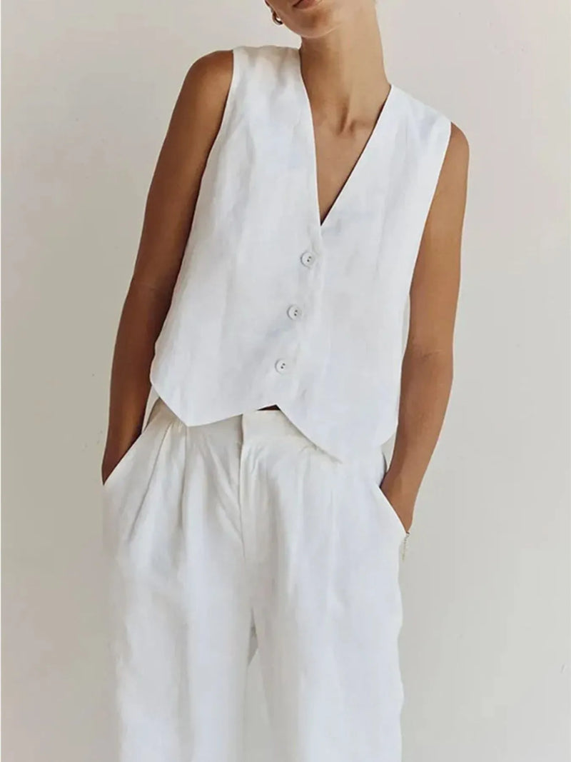 Person wearing a white vest over a plain background