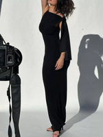 Person wearing a black outfit with a camera on a white background