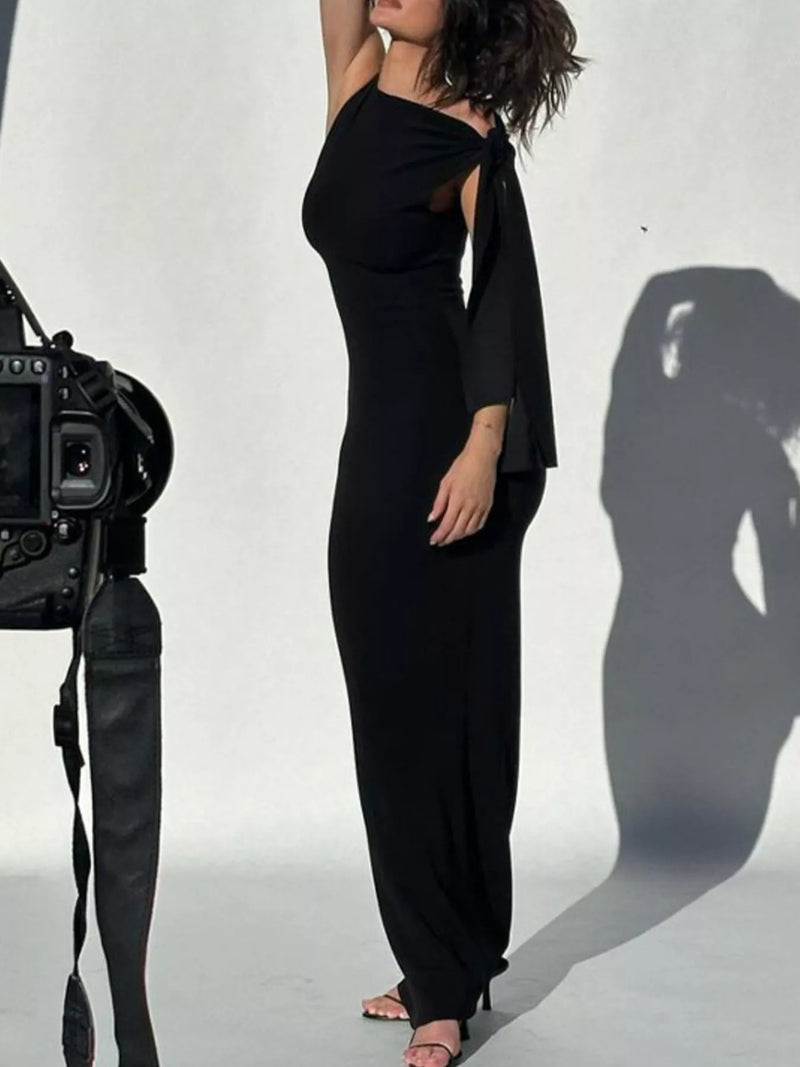 Person wearing a black outfit with a camera on a white background