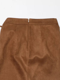 Close-up of a brown suede skirt on a white background