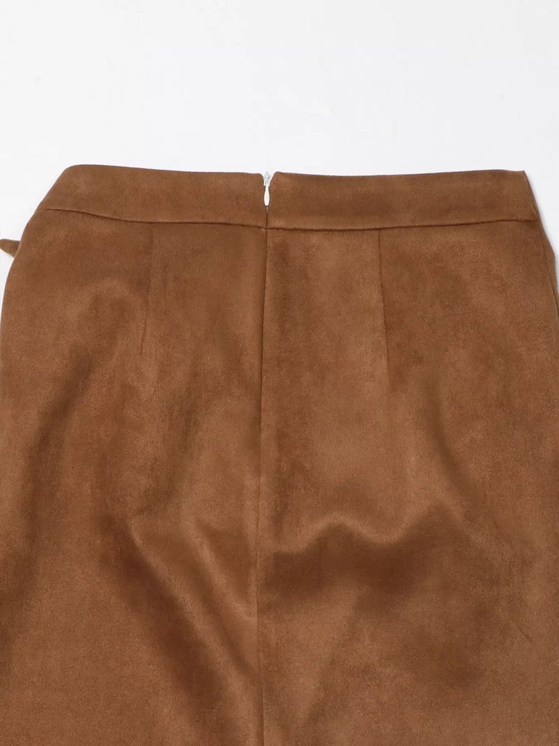 Close-up of a brown suede skirt on a white background