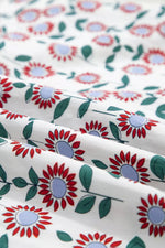 Floral patterned fabric with red, blue, and green flowers on a white background