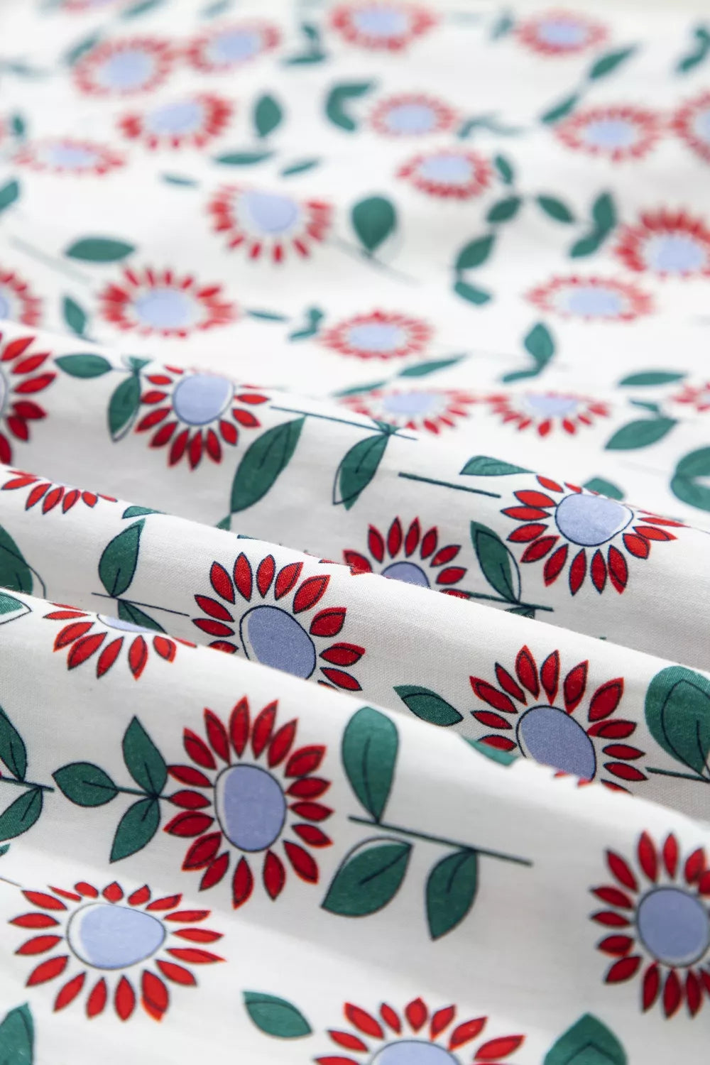 Floral patterned fabric with red, blue, and green flowers on a white background