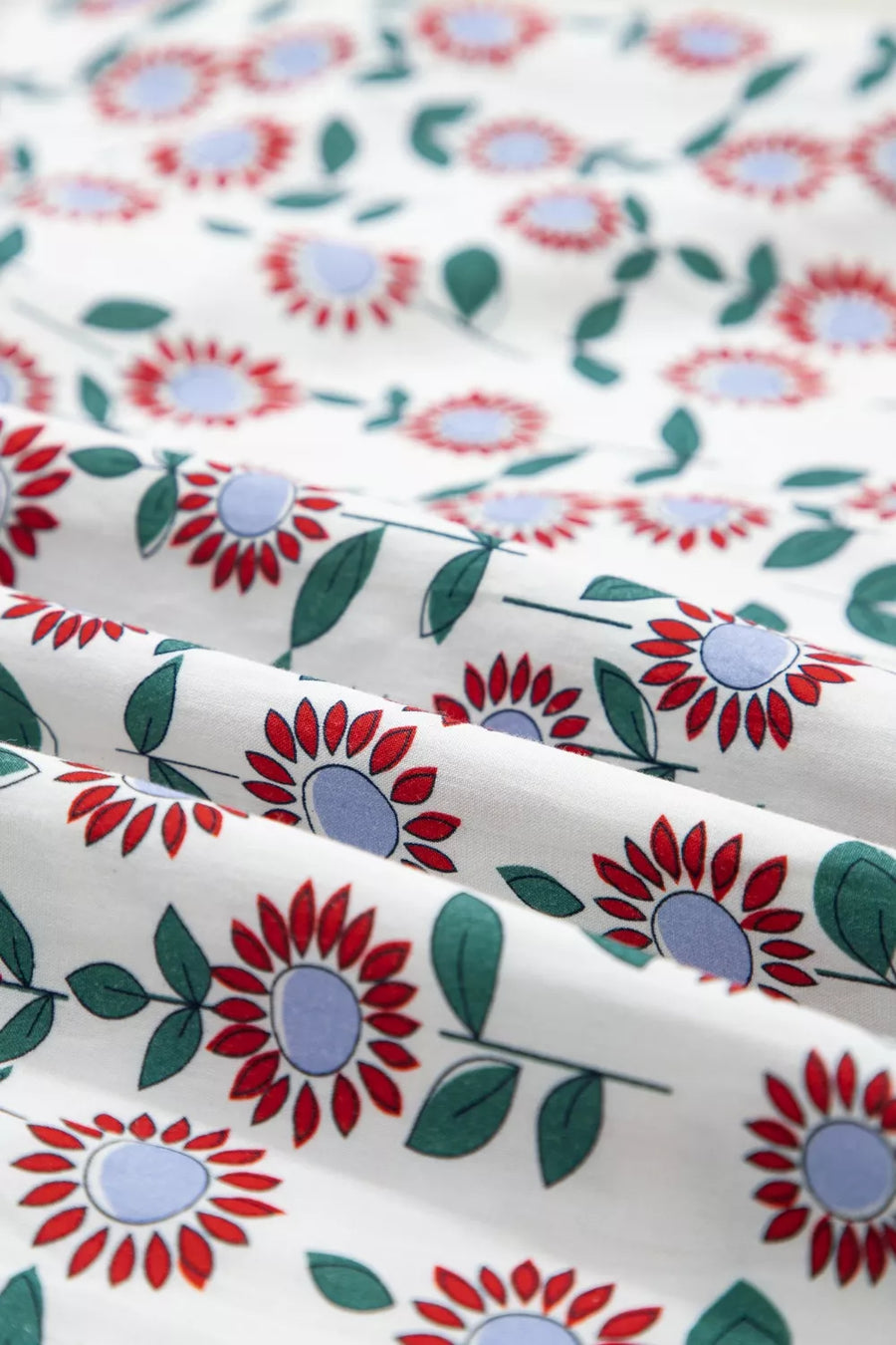 Floral patterned fabric with red, blue, and green flowers on a white background