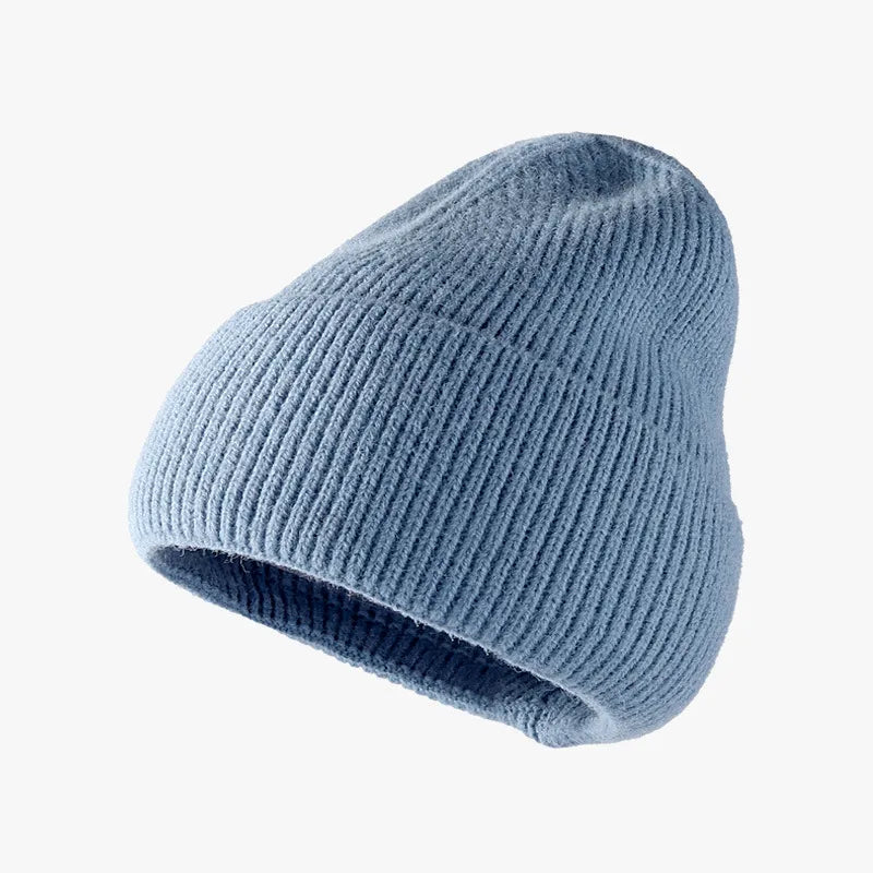 Blue knit beanie on a white background