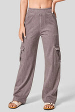 Person wearing brown cargo pants on a plain background