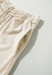 Beige pants with an elastic waistband on a light gray background