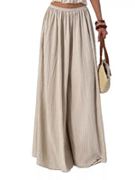 Beige wide-leg pants worn by a person on a white background