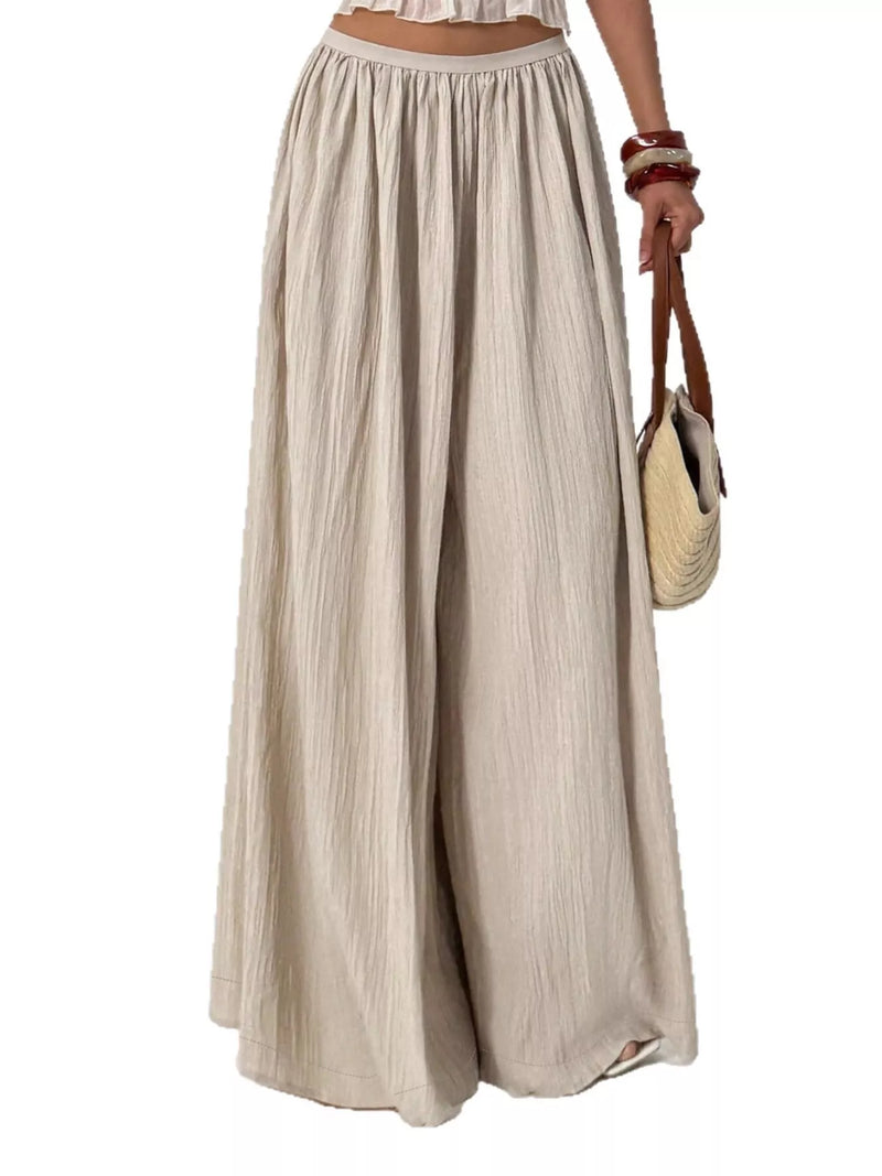 Beige wide-leg pants worn by a person on a white background