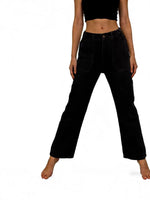 Person wearing black high-waisted jeans on a white background