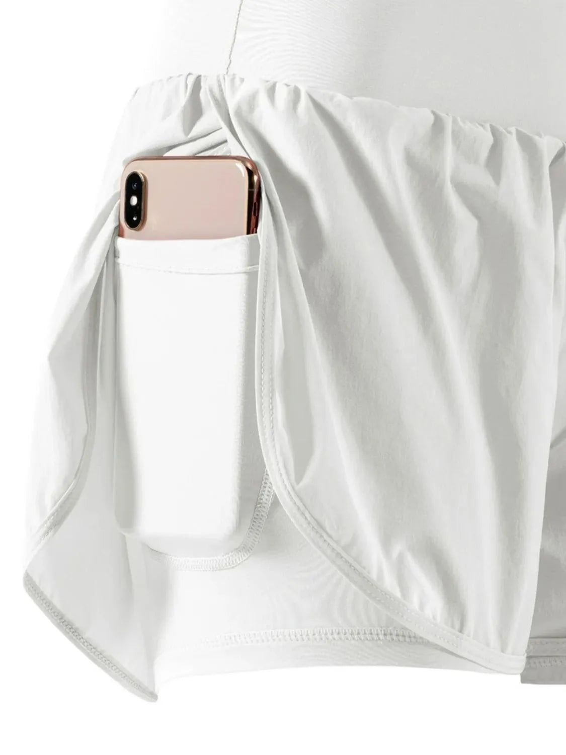 White shirt with a pocket holding a phone and case.
