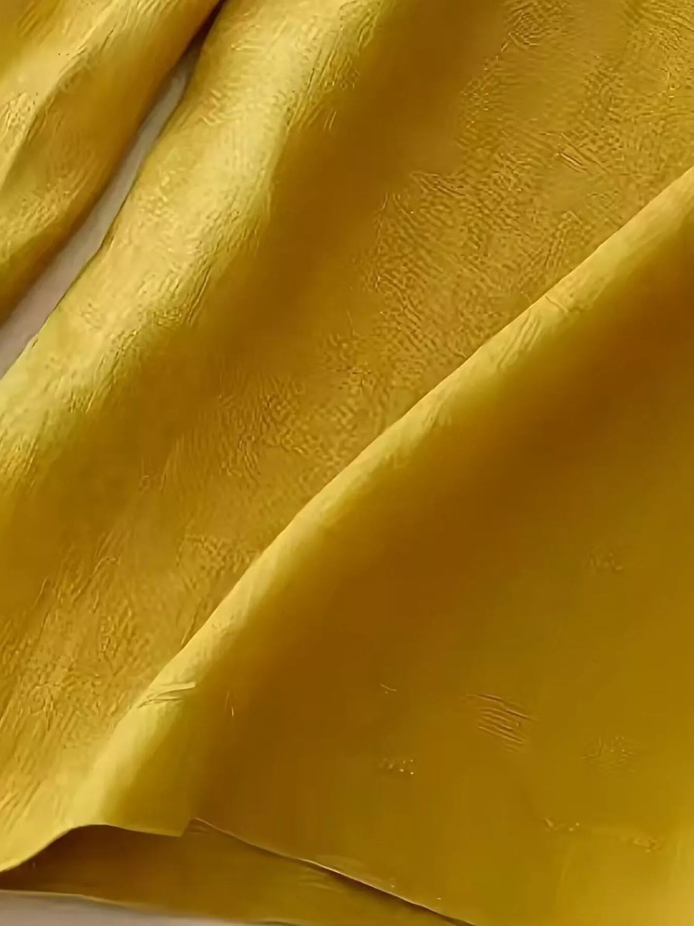 Close-up of textured yellow fabric