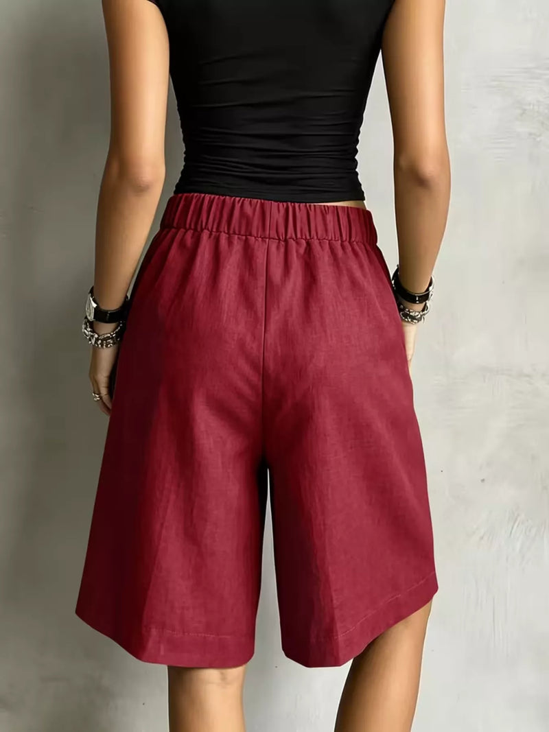A woman showing the back of burgundy High-Waisted Drawstring Shorts 