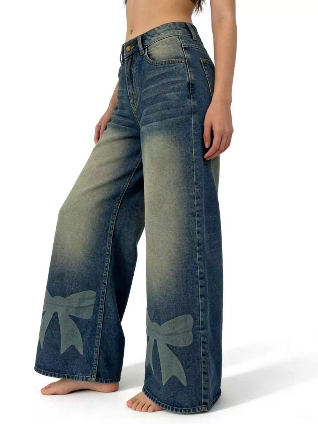 Blue jeans with bow designs on a white background