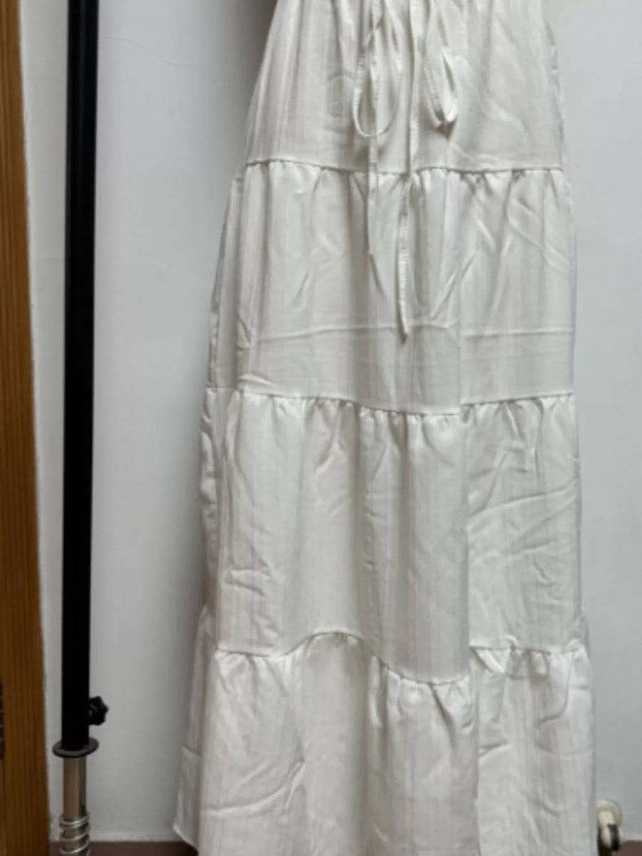 White tiered skirt against a plain background