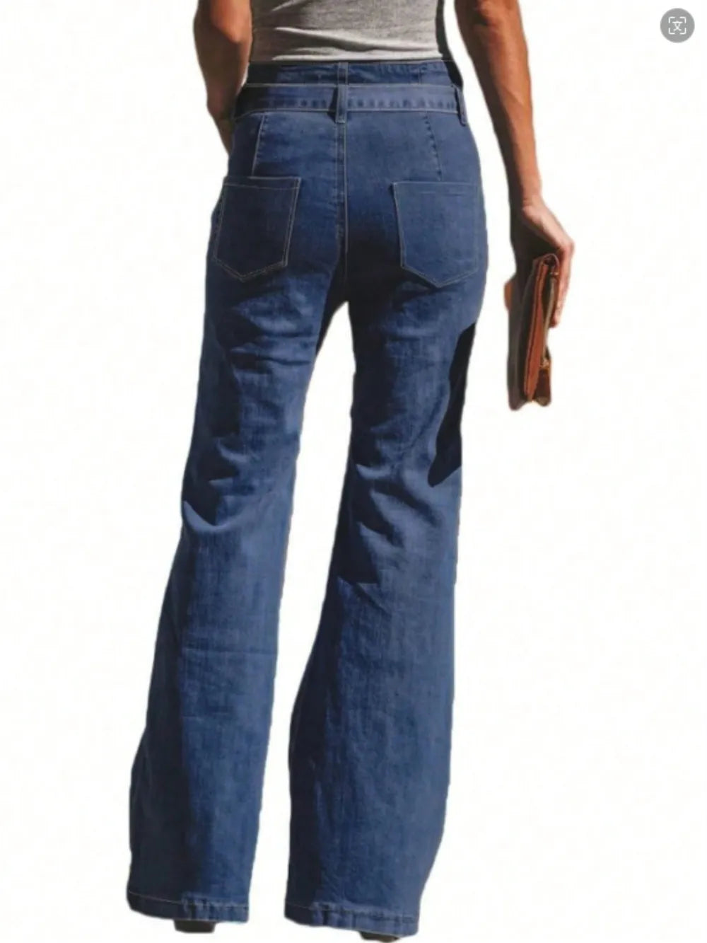 Blue jeans worn by a person on a white background