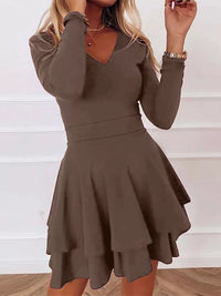 Brown dress worn by a person on a white background