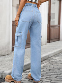 Person wearing light blue cargo jeans on a street.