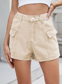 Beige shorts worn by a person on a neutral background