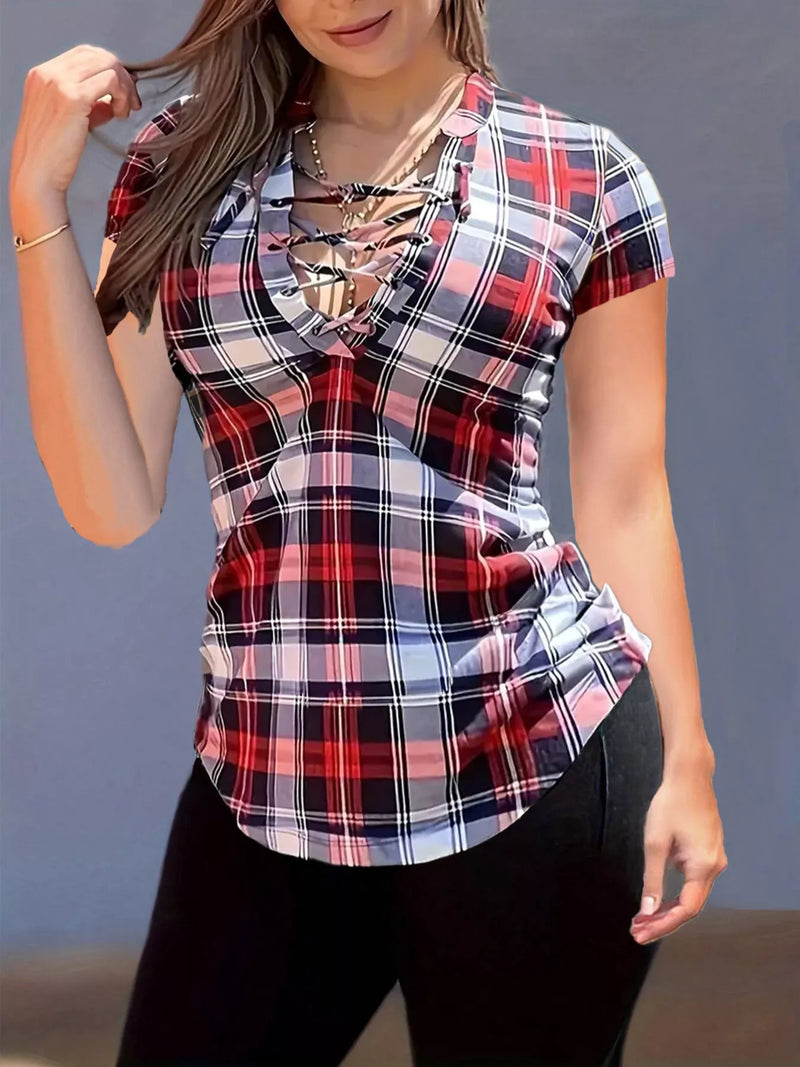 Person wearing a plaid shirt with a cut-out design against a gray background