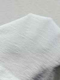 Close-up of a textured gray fabric on a light gray background