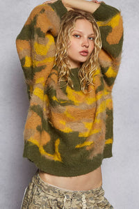 Woman wearing a patterned sweater against a plain background