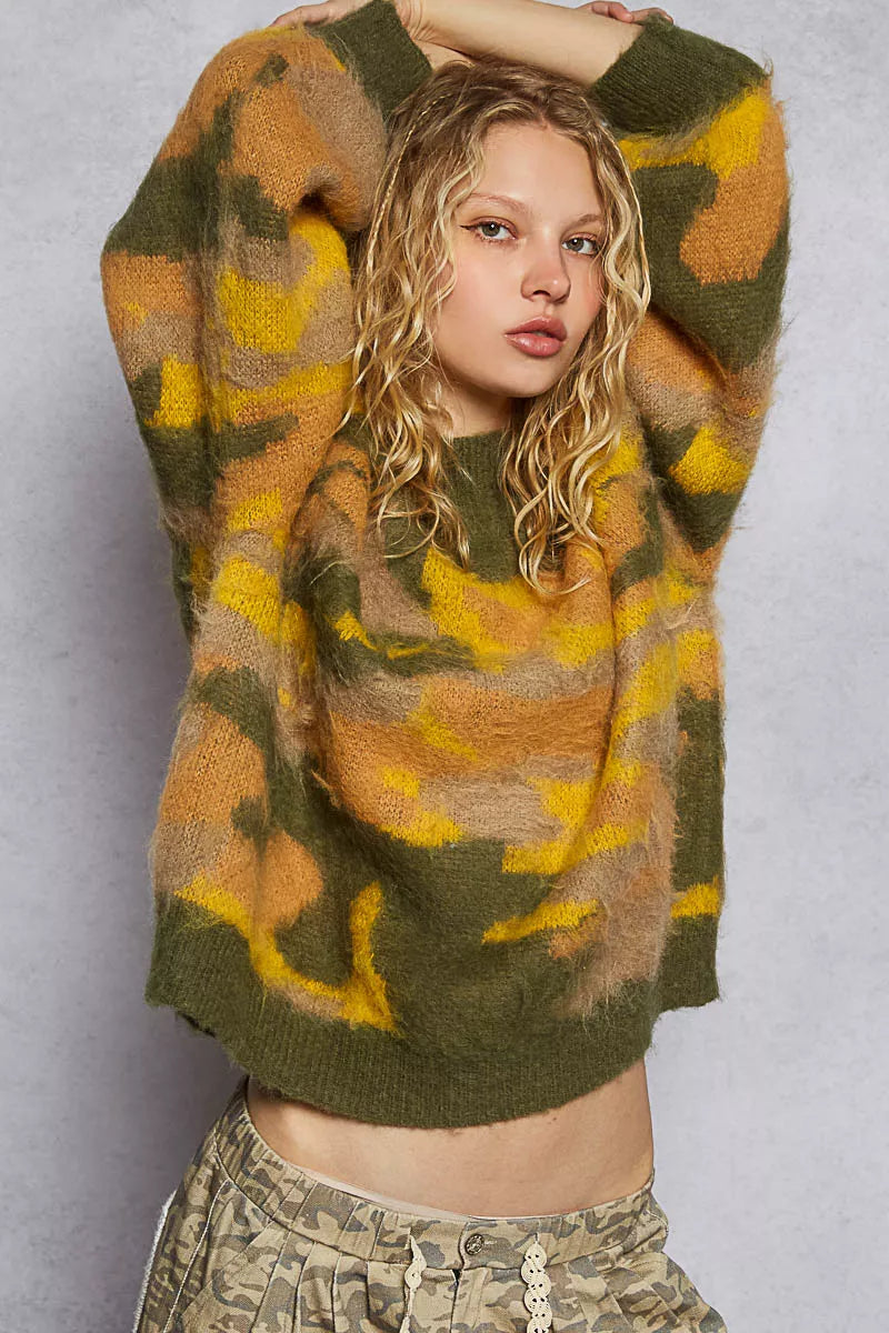 Woman wearing a patterned sweater against a plain background