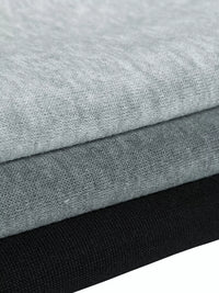 Stack of gray and black fabric swatches on a white background
