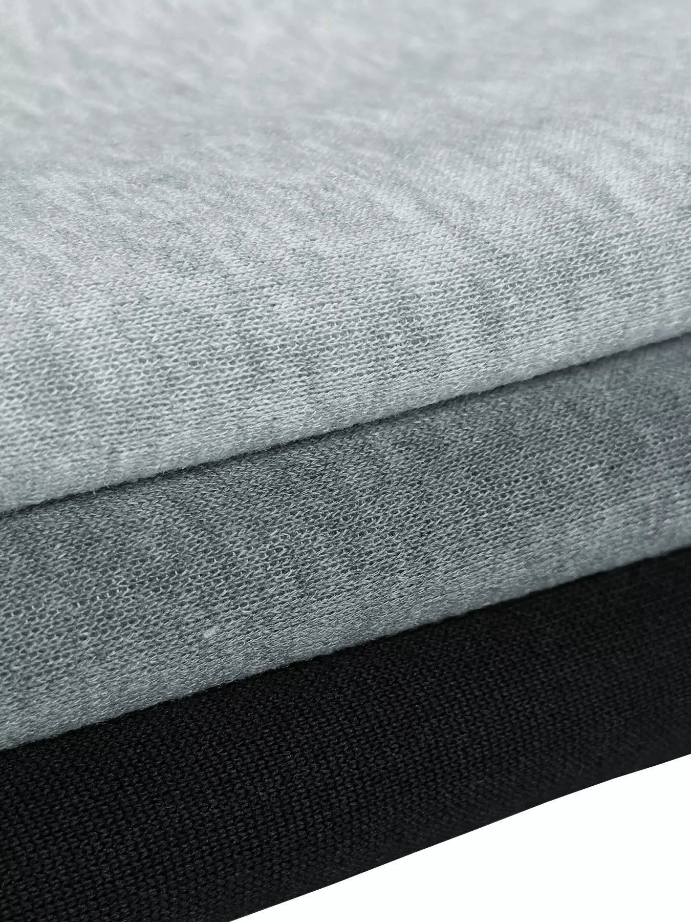 Stack of gray and black fabric swatches on a white background