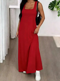 Person wearing a red dress with white sneakers indoors.