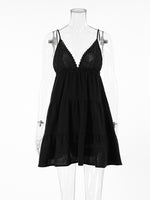 Black lace dress on a mannequin against a white background