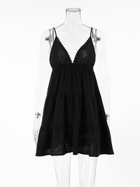 Black lace dress on a mannequin against a white background