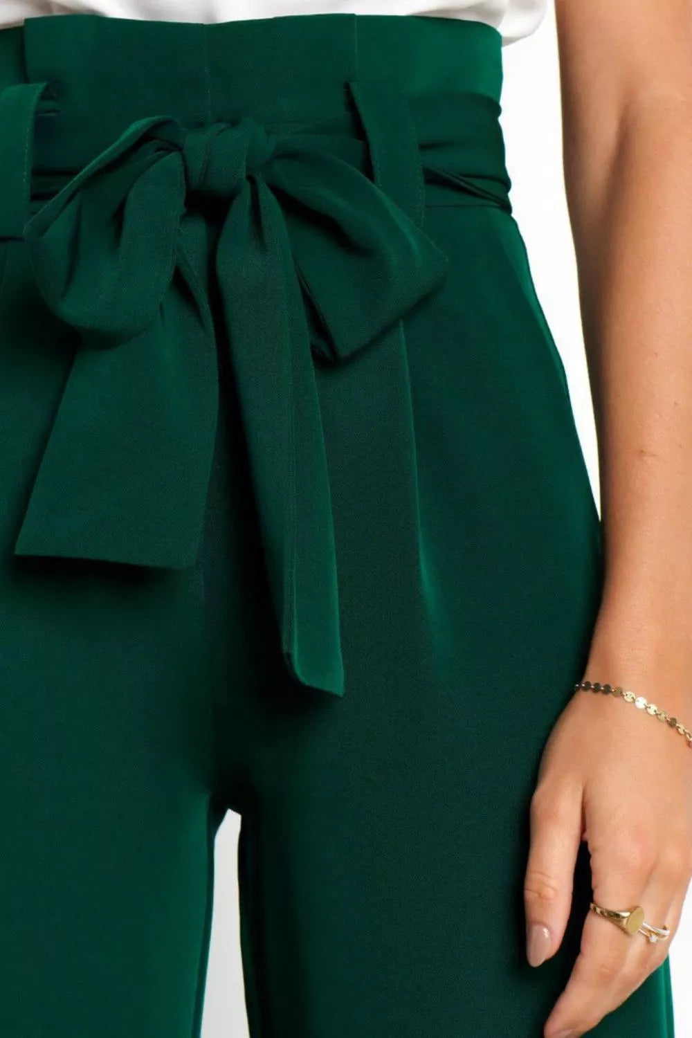 Green paperbag waist pants with a bow detail on a white background