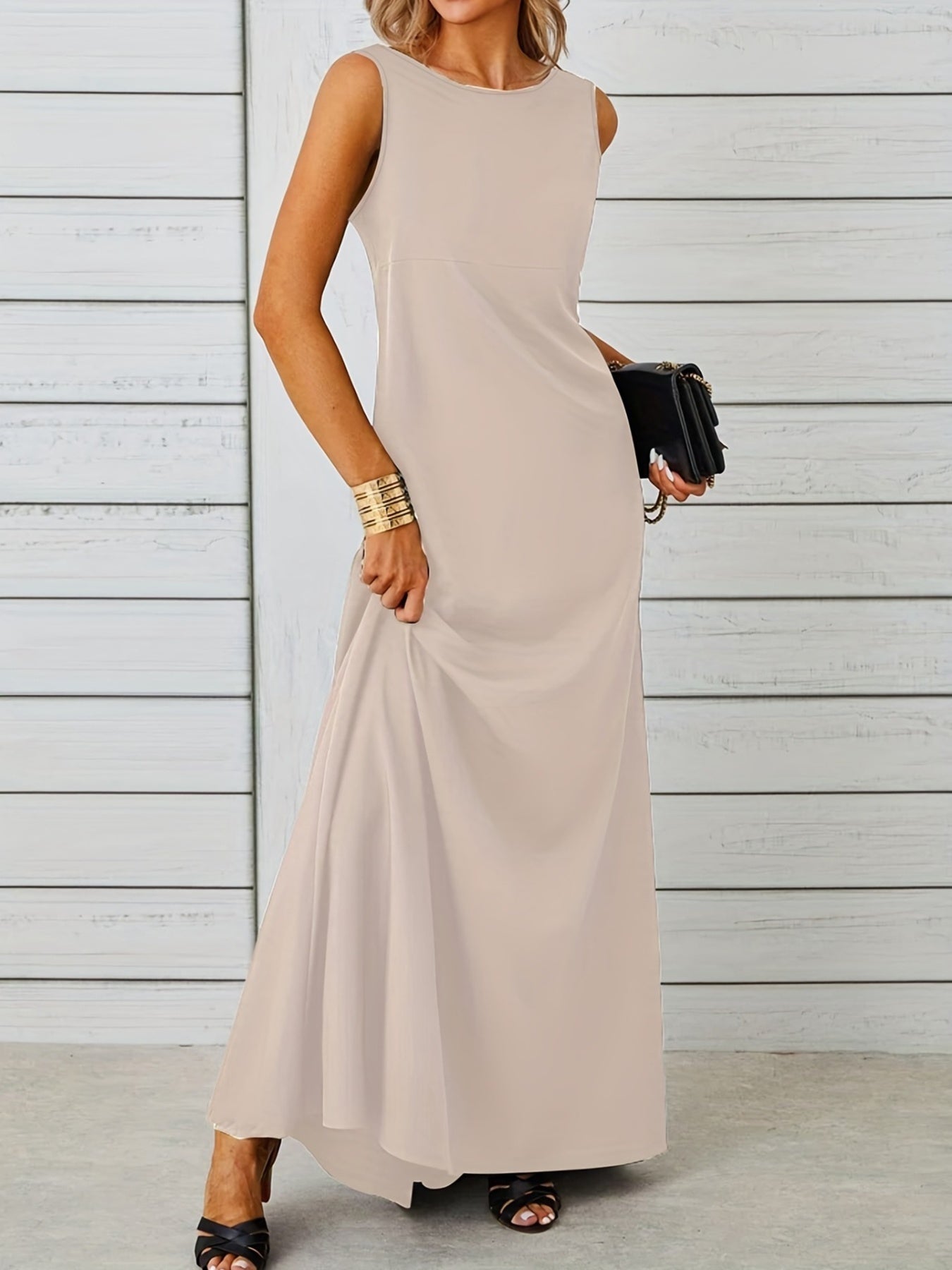 Woman wearing a beige sleeveless dress against a light wooden panel background