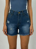 Blue denim shorts worn by a person on a plain background