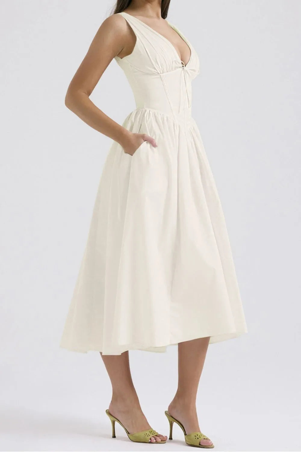 Woman wearing a white dress on a plain background