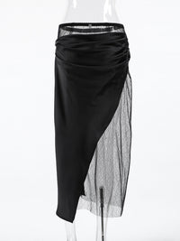 Black skirt with sheer overlay on a white background