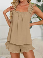 Woman wearing a beige sleeveless top and shorts set with a white background