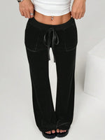 Black wide-leg pants worn by a person on a white background