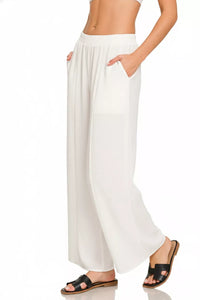 White wide-leg pants worn by a person on a white background