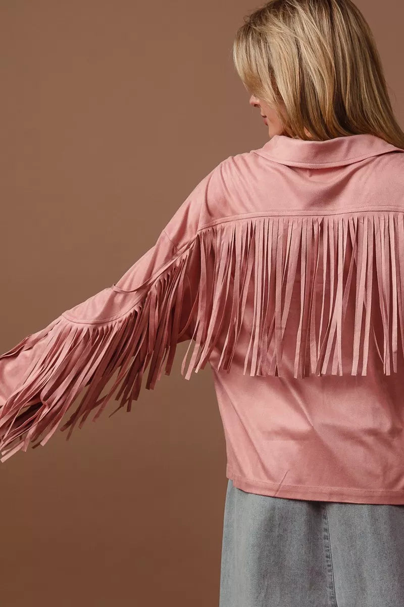 Pink fringed jacket worn by a person on a brown background