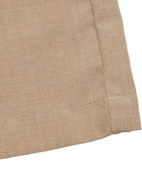 Close-up of beige fabric with a visible seam on a white background