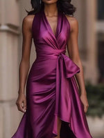 Woman wearing a purple satin dress with a blurred background