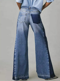 Wide-leg jeans worn by a person on a plain background