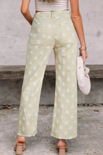 Person wearing light green polka dot pants with a neutral background